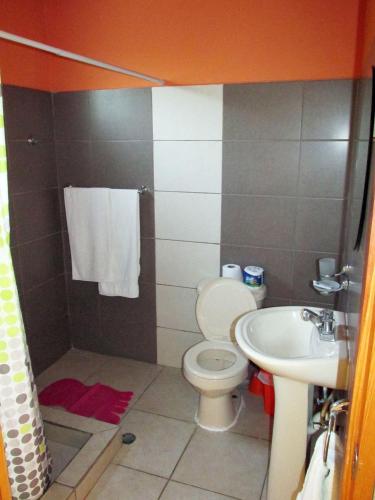 a bathroom with a toilet and a sink at Corales Punta Rusia in Punta Rucia