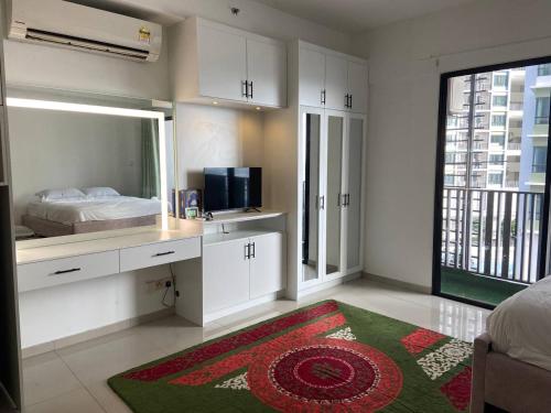 a white bedroom with a bed and a mirror at LF Homestay I-city Studio, Shah Alam in Shah Alam