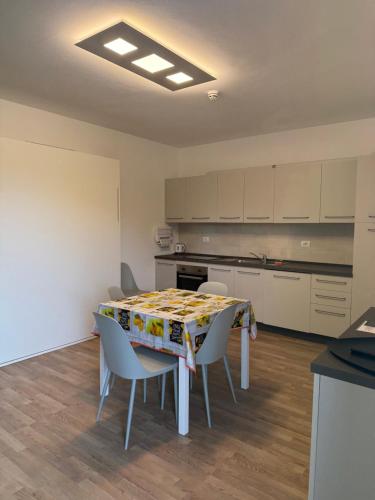 a kitchen with a table and chairs in a room at Residence San Francesco in Tirrenia
