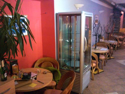 a restaurant with tables and chairs and an aquarium at Apartmán Susice in Sušice