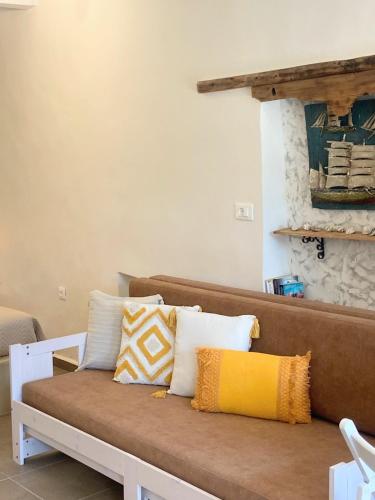 a couch with pillows on it in a living room at ALEMINAS House 1 in Symi