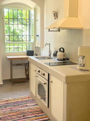 a kitchen with a sink and a stove at ALEMINAS House 1 in Symi