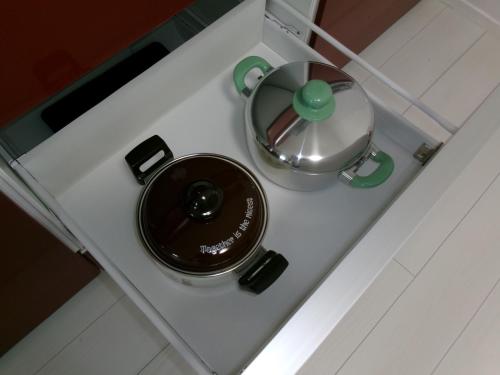 a stove top with a pot and a pan on it at Guest House OHANA in Kami-furano