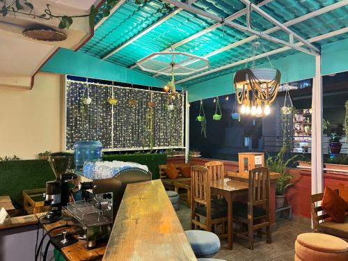 a restaurant with tables and chairs and blue ceilings at Holiday Hostel Kathmandu in Kathmandu