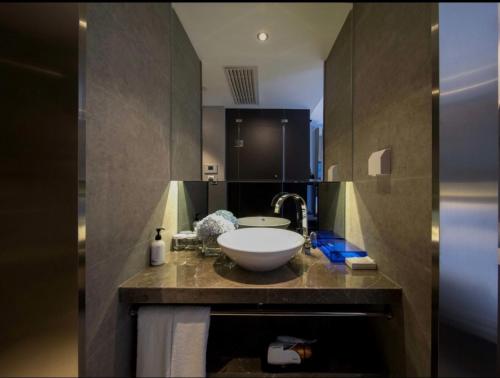 a bathroom with a white sink and a sink at Orange Hotel Beijing Shangdi Huandao in Beijing