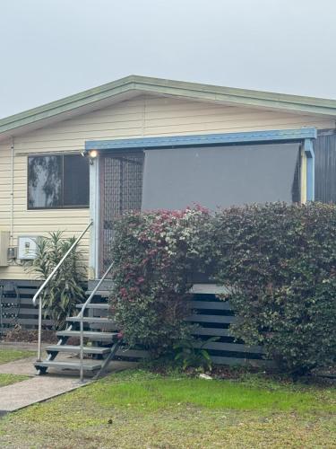 a house with a porch with a garage at Fishing Haven Holiday Park in Palmers Island