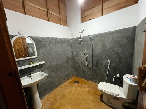 a bathroom with a shower and a sink at Sand Dune Beach Resort & Surf Camp in Arugam Bay
