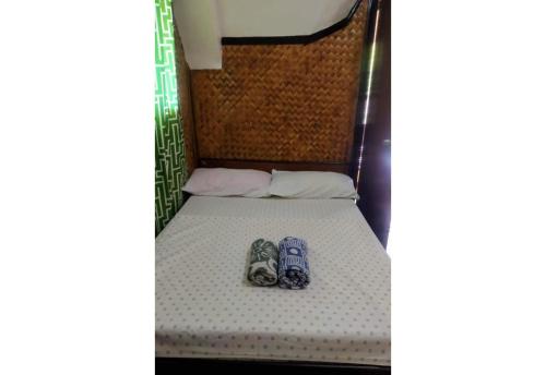 a pair of shoes sitting on a bunk bed at Moreno's Place in Boracay