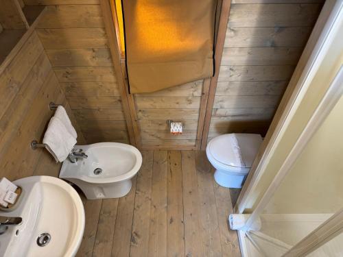 a small bathroom with a sink and a toilet at Terreforti Luxury Village in Agrigento