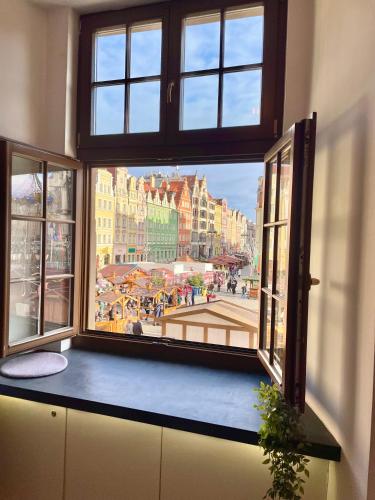 an open window with a view of a city at Wroclaw Inn Apartments in Wrocław
