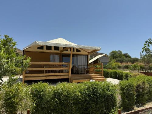 a tiny house with a roof on a garden at Terreforti Luxury Village in Agrigento