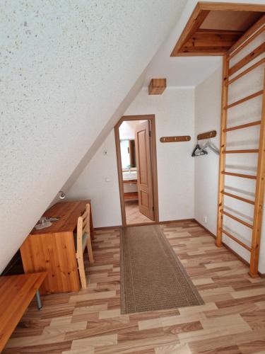 a room with a staircase and a wooden floor at Villa River Rose in Jõesuu