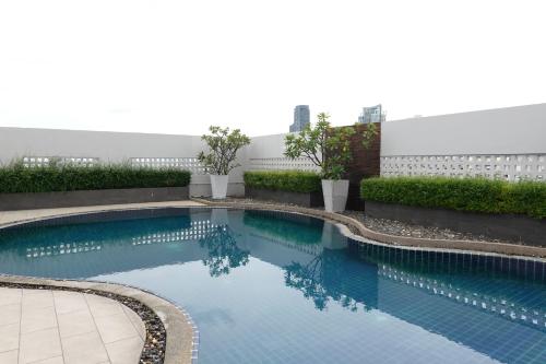 a swimming pool in the middle of a building at Nice view over the heart of Bangkok in Bangkok