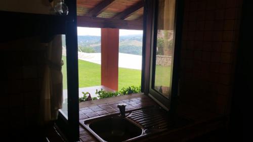 a kitchen sink with a view of a window at Villa Greco in Rossano