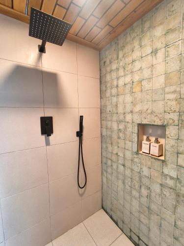 a shower in a bathroom with a shower head at Villa Anvaya in Pasuruan