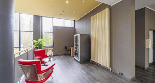 an office with red chairs and a table and windows at Best Western Plaza Hotel Zwickau in Zwickau