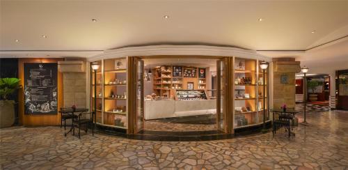 a lobby of a hotel with tables and chairs at Grand Hyatt Erawan Bangkok in Bangkok