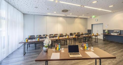 a conference room with tables and chairs with laptops at Best Western Plaza Hotel Zwickau in Zwickau