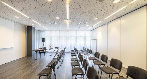 a conference room with chairs and a table and a podium at Best Western Plaza Hotel Zwickau in Zwickau