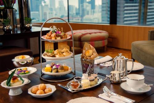 a table with a tray of breakfast food on it at Grand Hyatt Erawan Bangkok in Bangkok