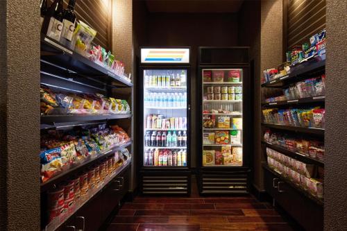 a grocery store aisle with two refrigerators and food at Hyatt House Seattle/Redmond in Redmond