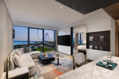 a living room with a view of the roller coaster at Hotel Indigo Suzhou Jinji Lake by IHG in Suzhou