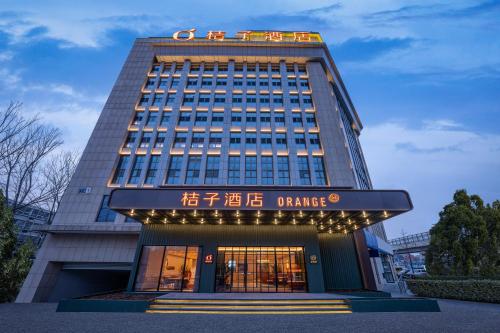 a building with a sign on top of it at Orange Hotel Beijing Liangxiang University Town in Beijing