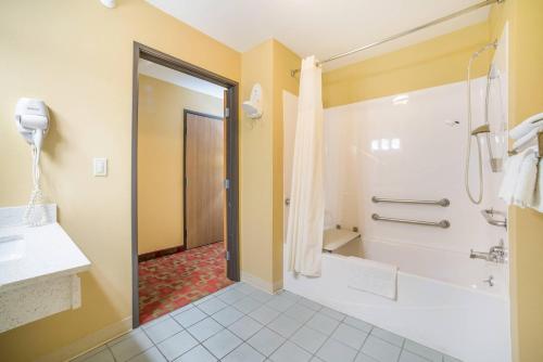 a bathroom with a tub and a shower and a sink at Quality Inn O'Fallon IL - St Louis in O'Fallon