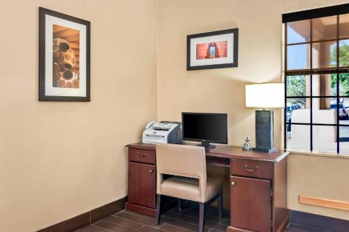 a room with a desk with a computer and a printer at Comfort Inn in Santa Fe
