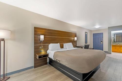 a hotel room with a bed and a bathroom at Quality Inn & Suites Orangeburg in Orangeburg