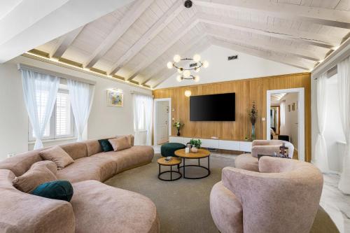 a living room with couches and a flat screen tv at Luxury villa Lia in Dubrovnik