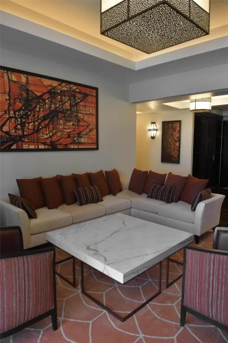 a living room with a couch and a coffee table at Hilton Tangier Al Houara Resort & Spa in Al Houara