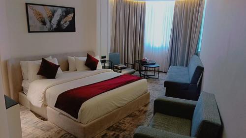 a hotel room with a bed and a chair at Roya Downtown Boutique Hotel in Amman
