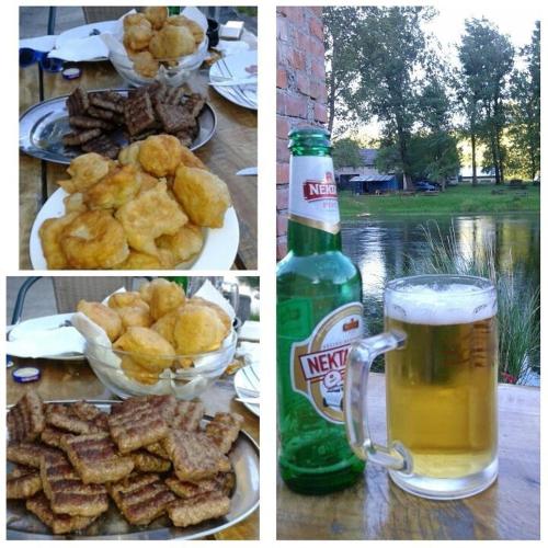 a table with a plate of food and a bottle of beer at Bed and Breakfast Family Djukic in Šipovo