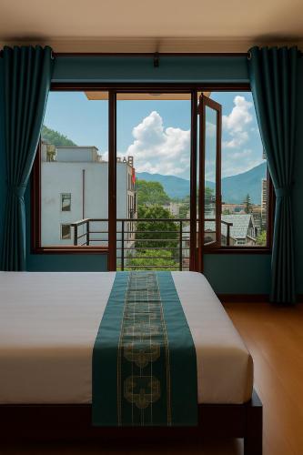 a bedroom with a bed and a large window at Sapa Elegance Hotel in Sa Pa