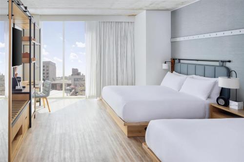 a hotel room with a bed and a large window at Hyatt Centric Center City Philadelphia in Philadelphia