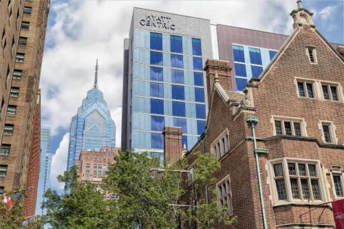 a tall building with a sign on it in a city at Hyatt Centric Center City Philadelphia in Philadelphia