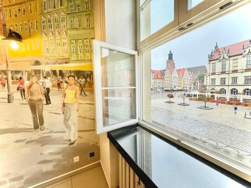 a window with a view of a city street at Wroclaw Inn Apartments in Wrocław