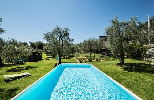 a swimming pool in the yard of a house at Campolivo in Gargnano