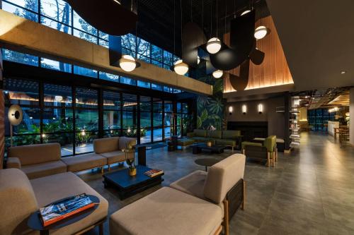a lobby of a hotel with couches and tables at Faranda Collection Medellin, a Member of Radisson Individuals in Medellín