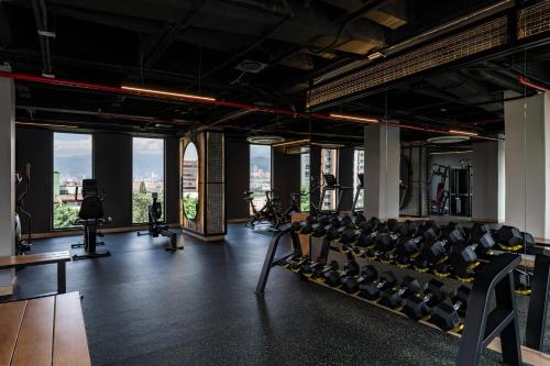 a gym with chairs and a view of the city at Faranda Collection Medellin, a Member of Radisson Individuals in Medellín