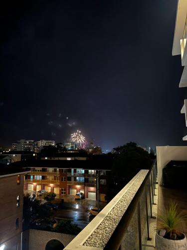 a view of a city at night from a balcony at beach pad in Wollongong