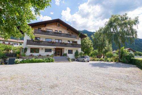 a house with a car parked in front of it at Pension Baumgarten in Naturno