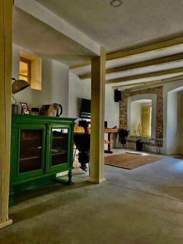 a living room with a green cabinet and a table at Tri Srca 1 - De Luxe 1 in Trebinje