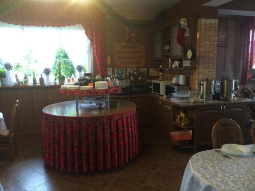 a kitchen with a table with food on it at Ośrodek Wypoczynkowy Bernadetta in Murzasichle