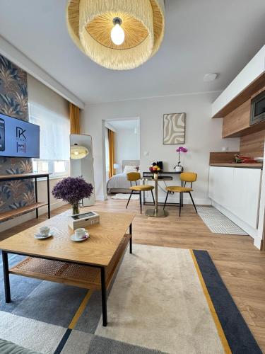 a living room with a table and a dining room at Hélios Plage in Berck-sur-Mer