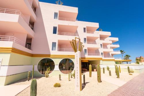 a building with cacti in front of it at Grand Paradiso Ibiza - Adults Only in San Antonio Bay
