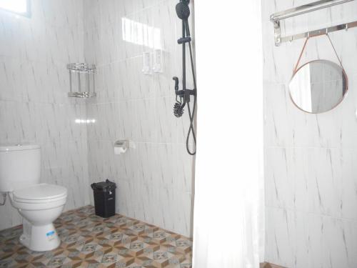 a bathroom with a shower and a toilet in it at Manik Villa Besakih in Besakih