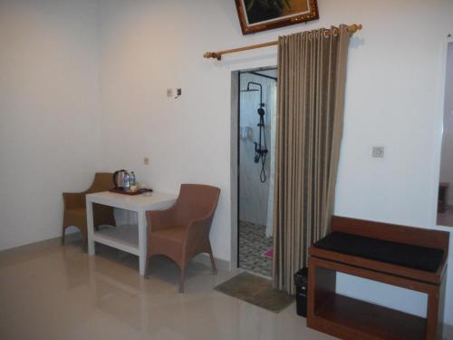 a room with a table and chairs and a mirror at Manik Villa Besakih in Besakih