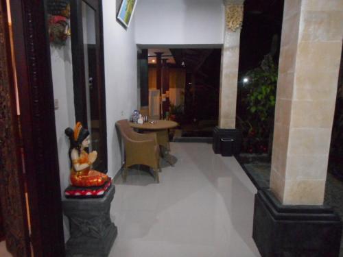 a hallway with a table and chairs in a building at Manik Villa Besakih in Besakih